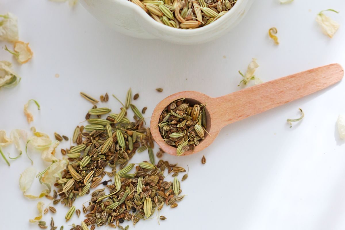 Fennel seeds (saunf) in a wooden spoon, a traditional Ayurvedic digestive after meals